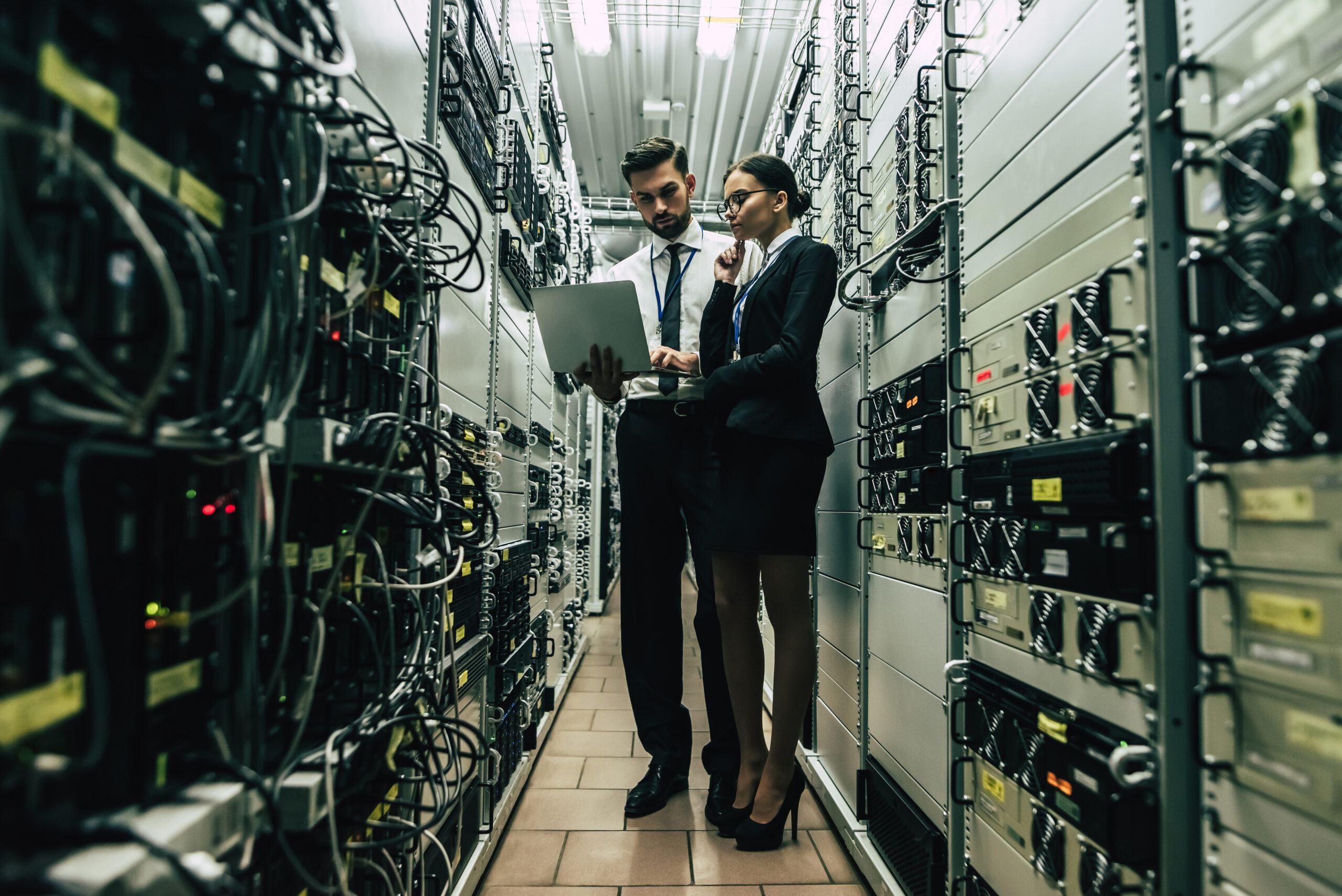 Technology specialists working in a data center representing secure infrastructure and managed IT
